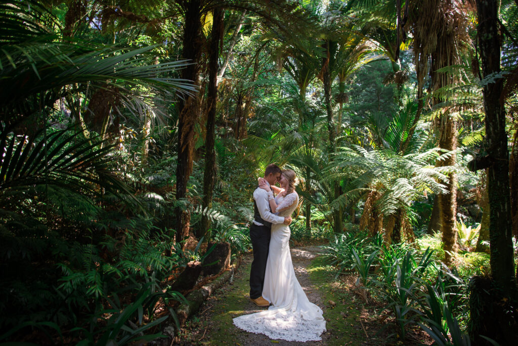 bride and groom standing in jungle in destination wedding