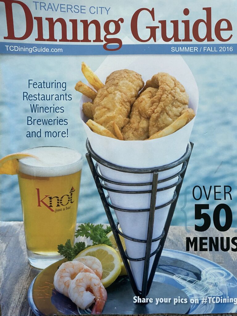 northern michigan traverse city dining guide magazine with the knotbar and grill cover by lina lavonne photography