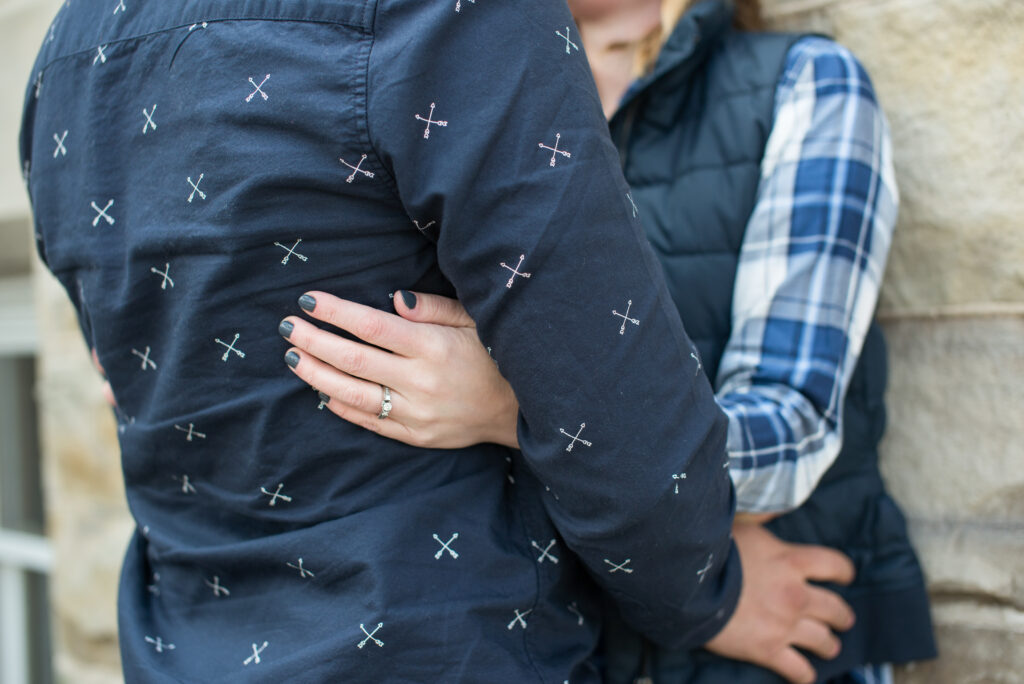 close up of ring on couple during engagement photos in traverse city michigan