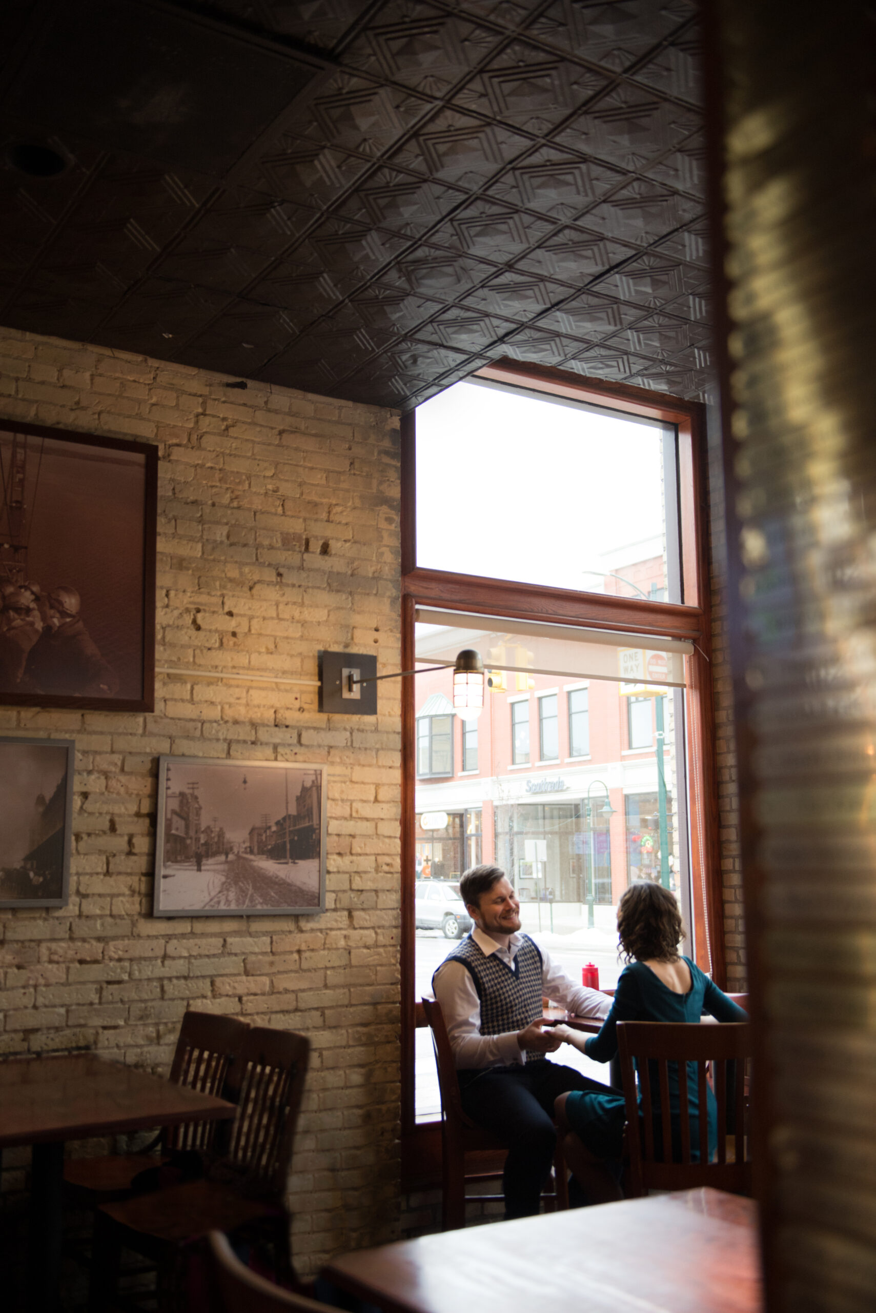 bride and groom at barduring engagement photos in traverse city