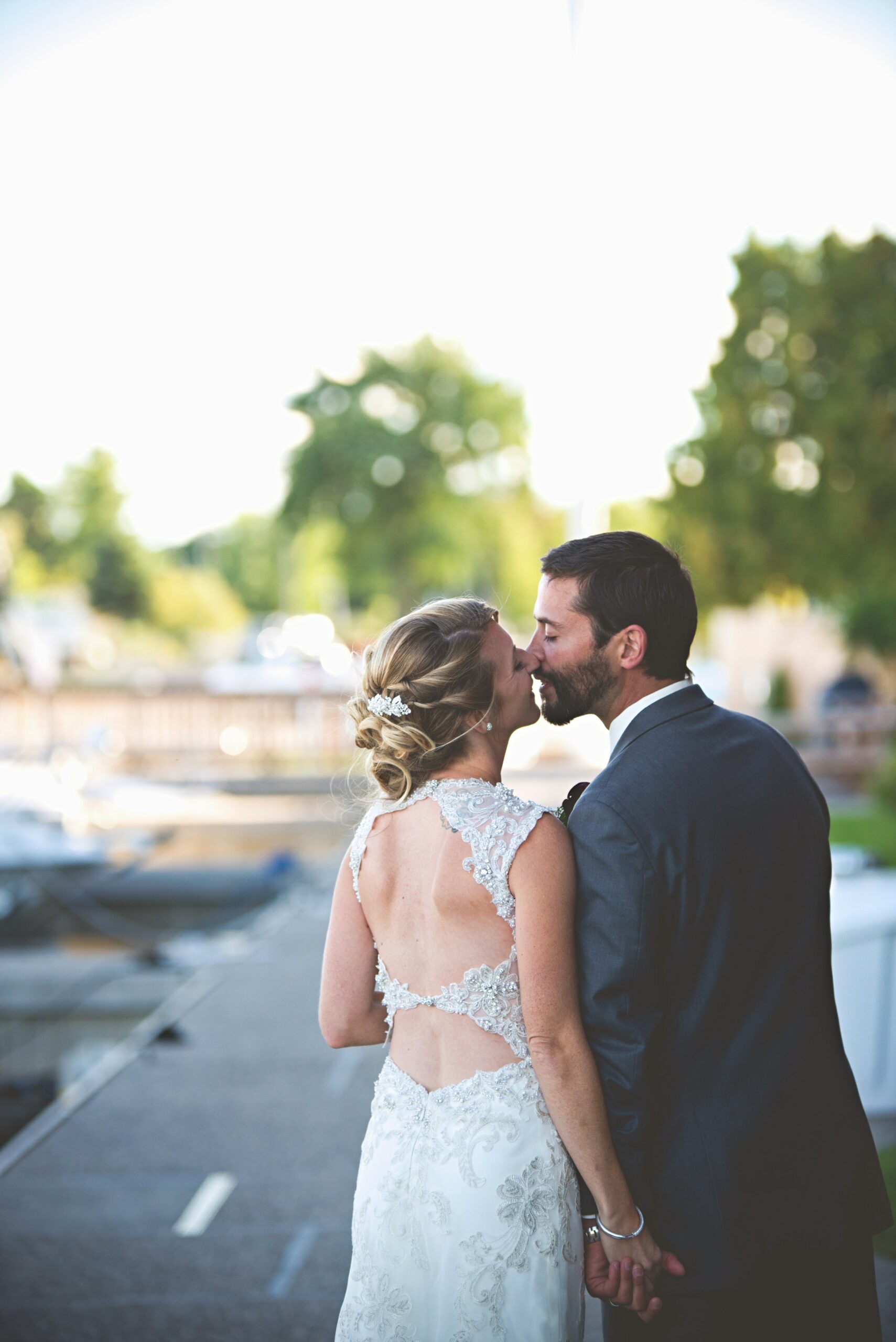 northern michigan bride and groom walking along lake michigan kissing