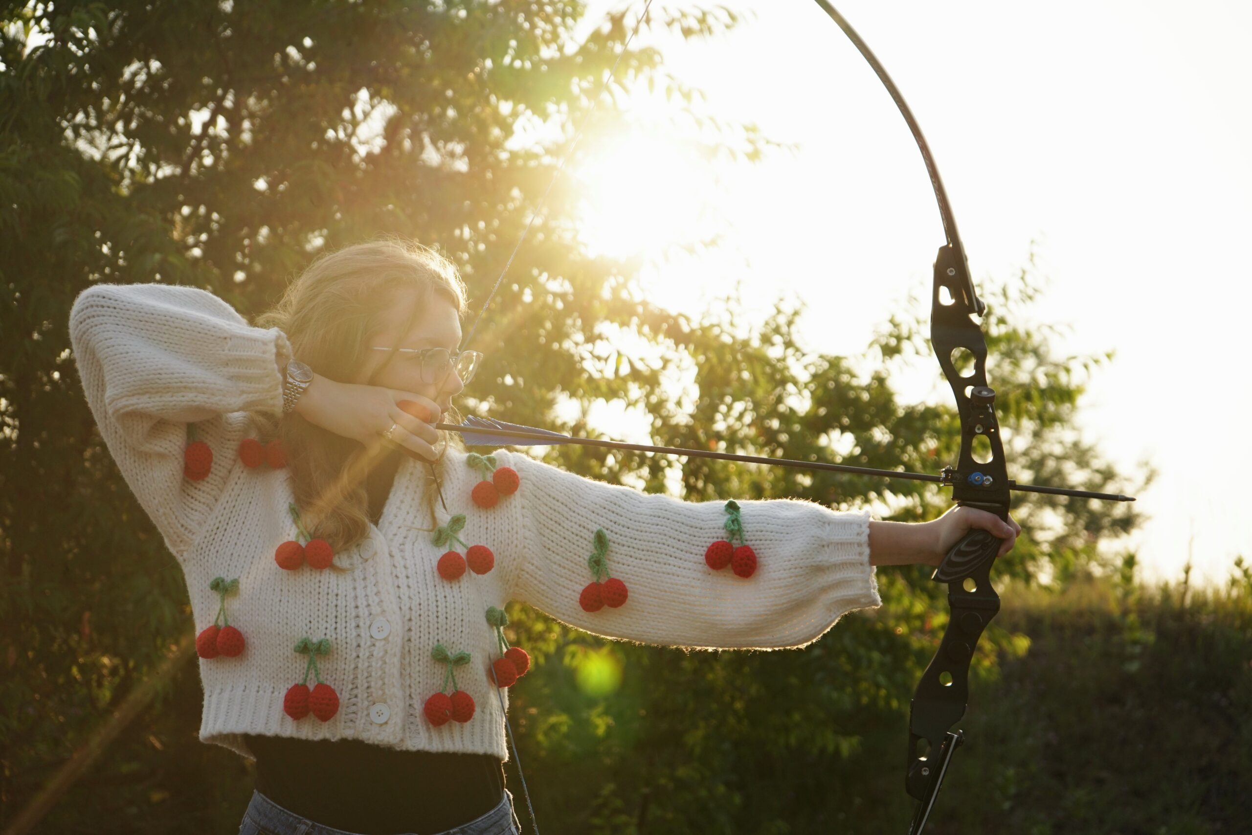 high school senior posing with archery backlit fine art photographhy
