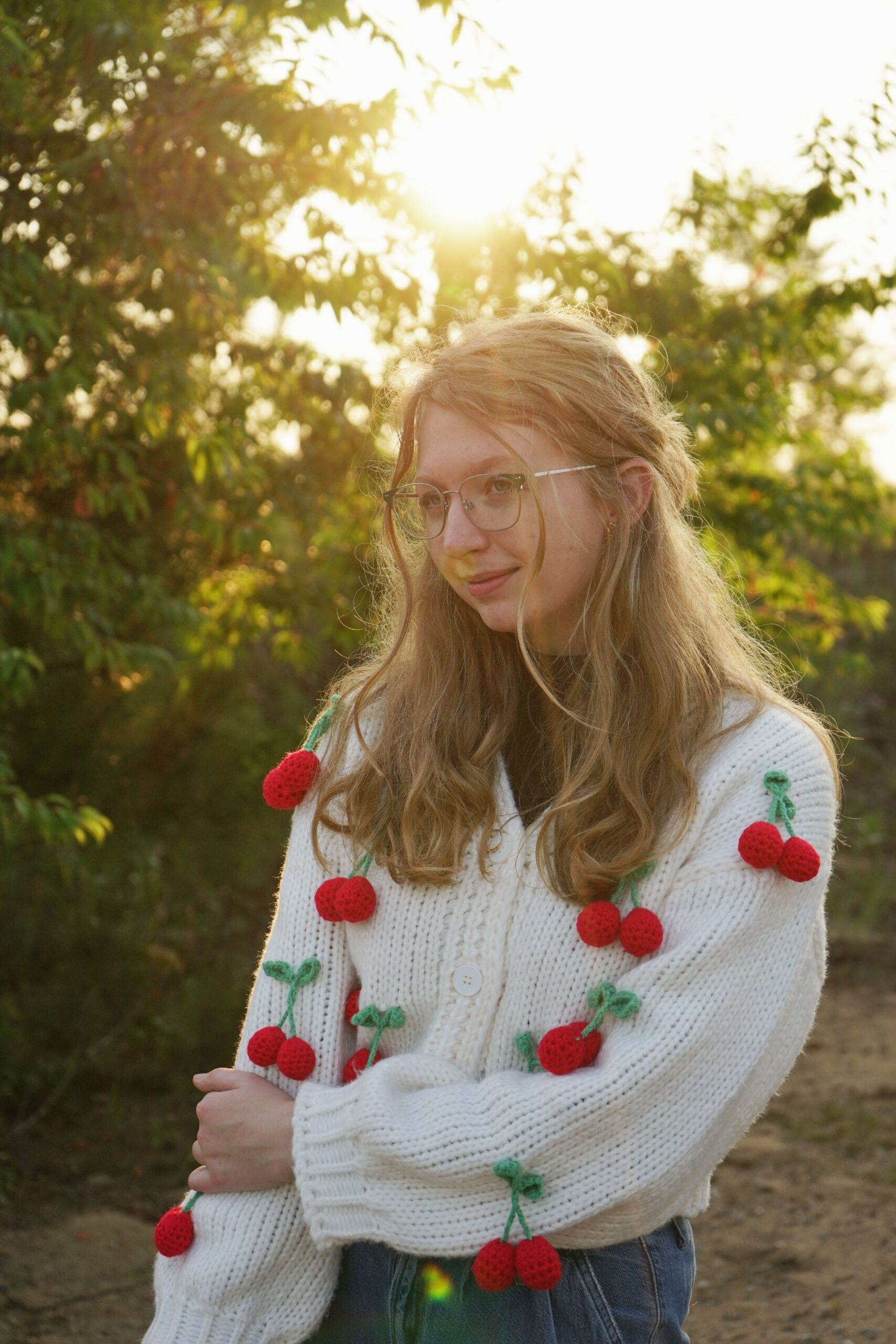 high school senior standing in field backlit in northern michigan