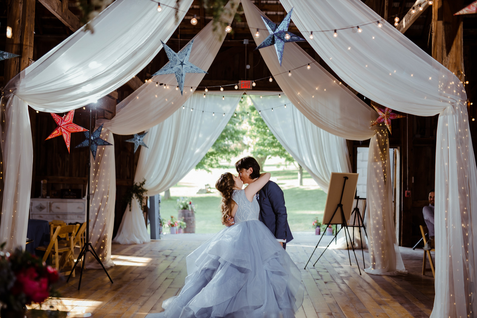 bride and groom dancing under celestial ceiling at starry night barn in suttons bay michigan