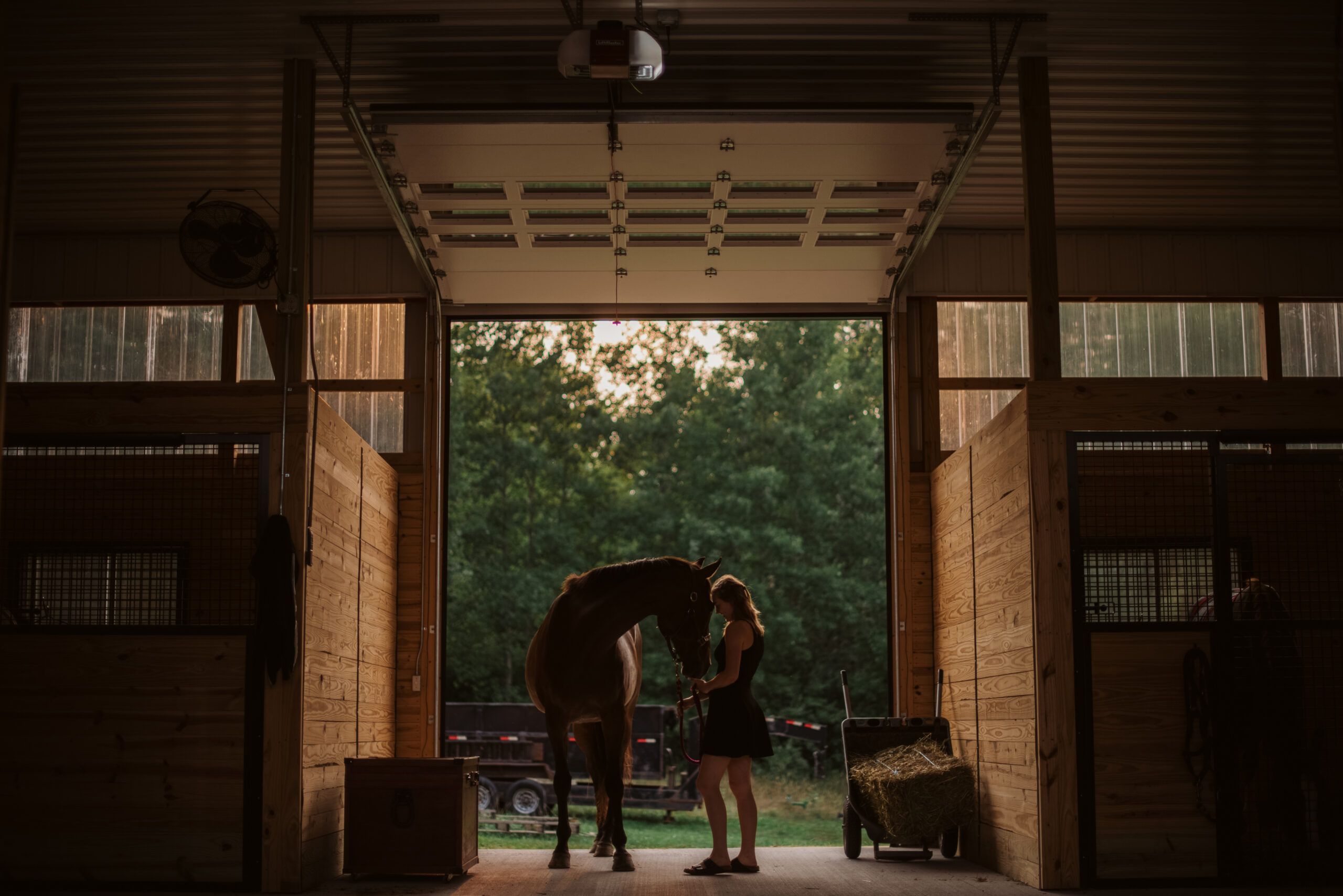 high school senior sitting in field during senior pictures in traverse city photographer