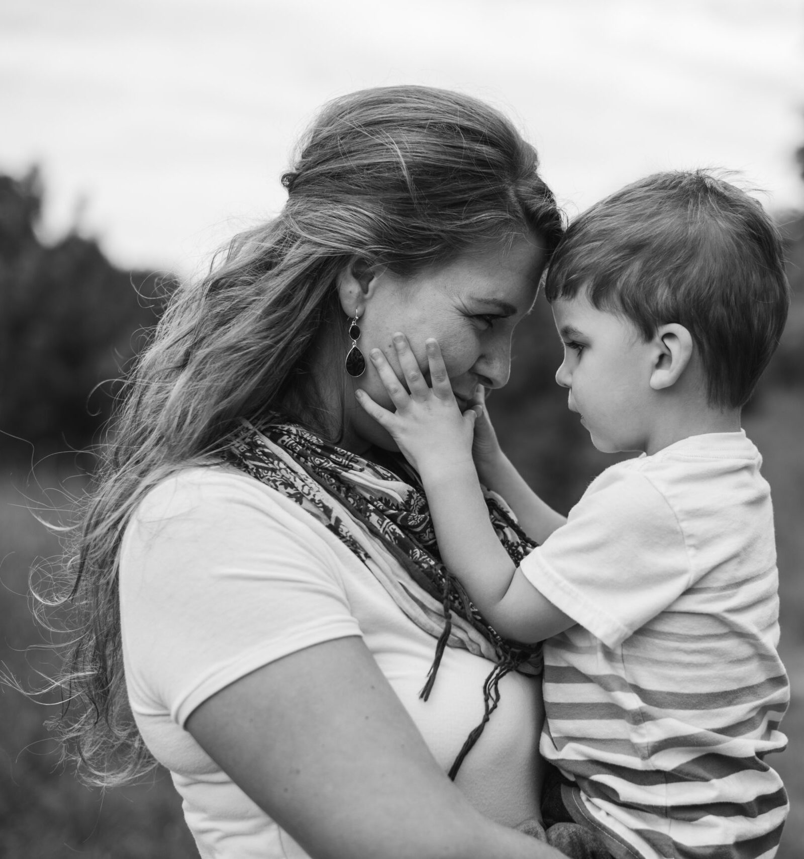 mother and son cuddling for family photos in traverse city michigan