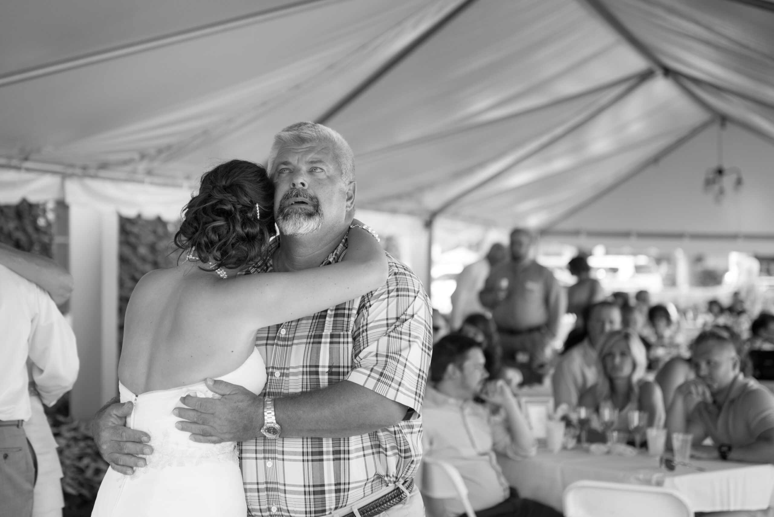father of the bride crying while dancing with bride at wedding in traverse city michigan