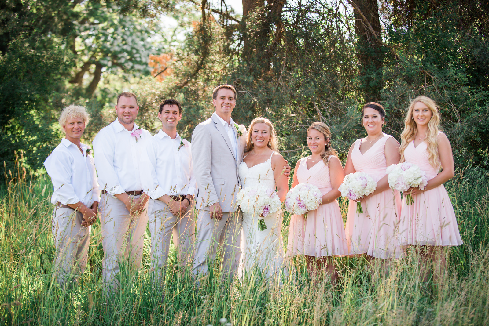 bridal party portrait standing in field in traverse city michigan