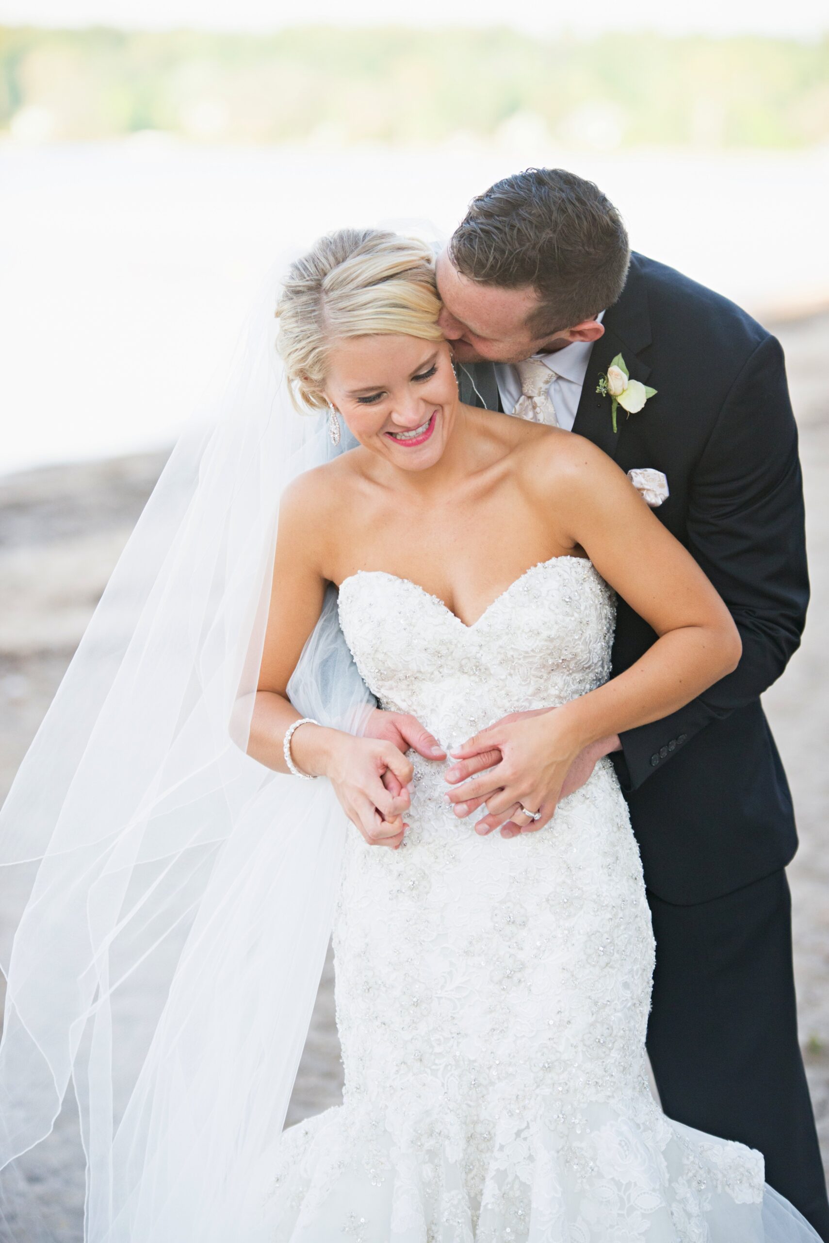 bride and groom embrace on grand traverse bay michigan