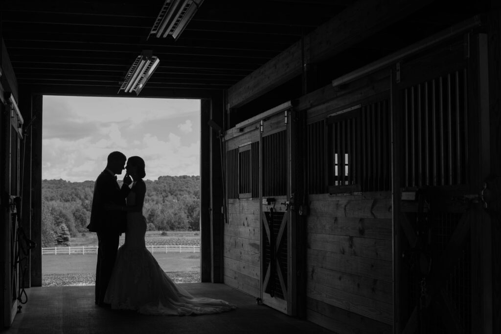 bride and groom silhouette in barn black and white in traverse city michigan