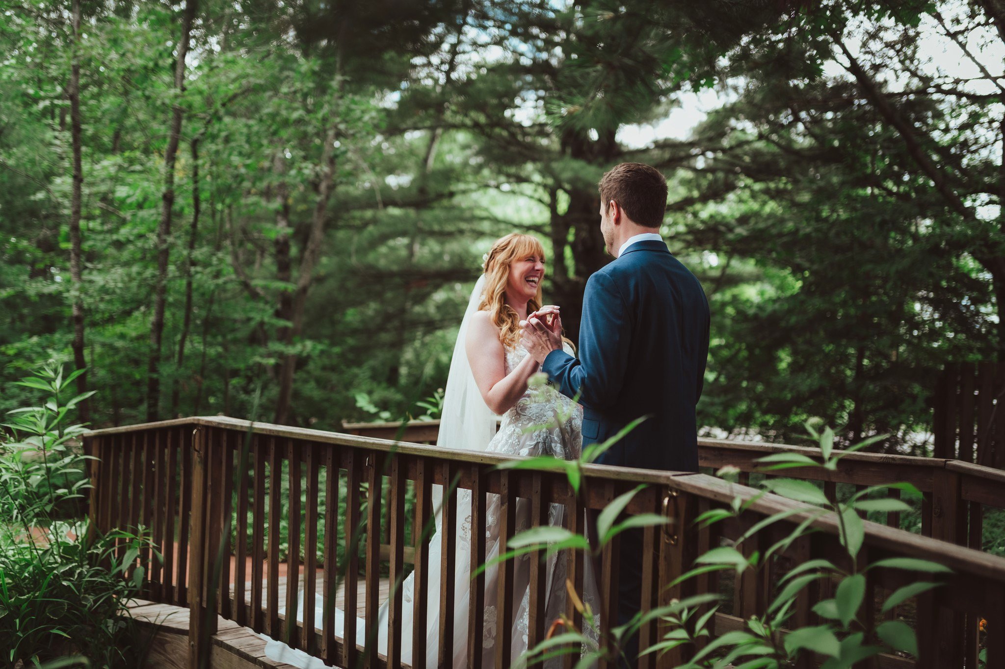 bride and groom at first look on bridge at blue bridge event center traversecitynmichigan