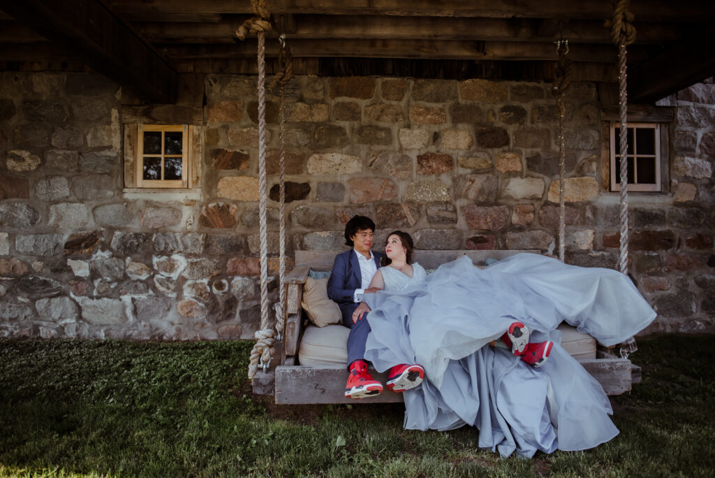 bride and groom cuddling on swing at barn wedding in traverse city michigan