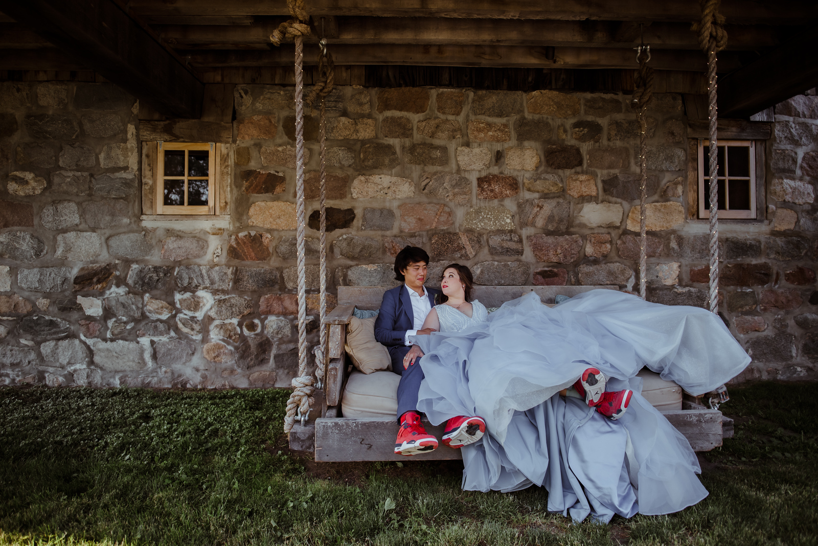 bride and groom cuddling on swing at barn wedding in traverse city michigan