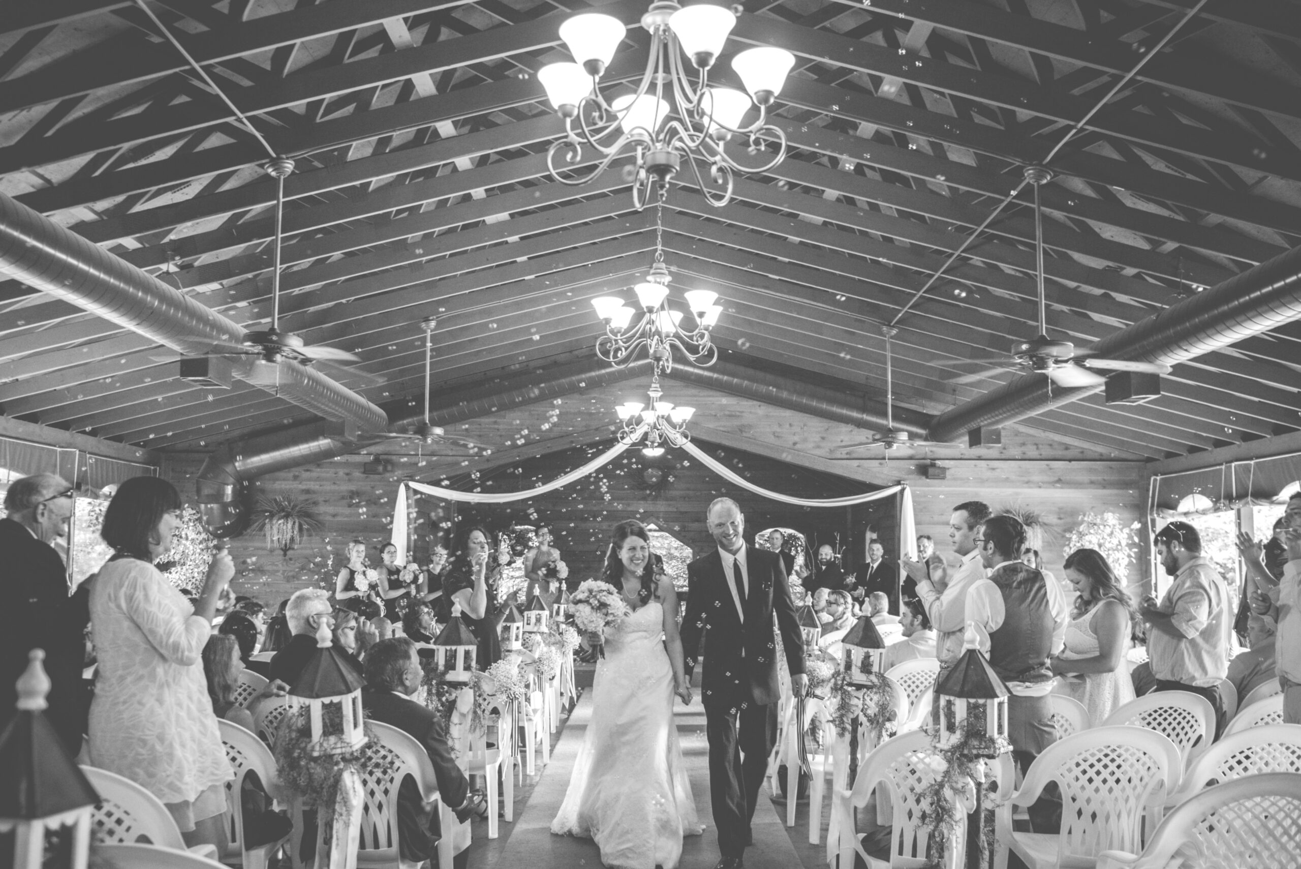 candid of bride and groom after wedding ceremony at blue bridge event center in interlochen michigan