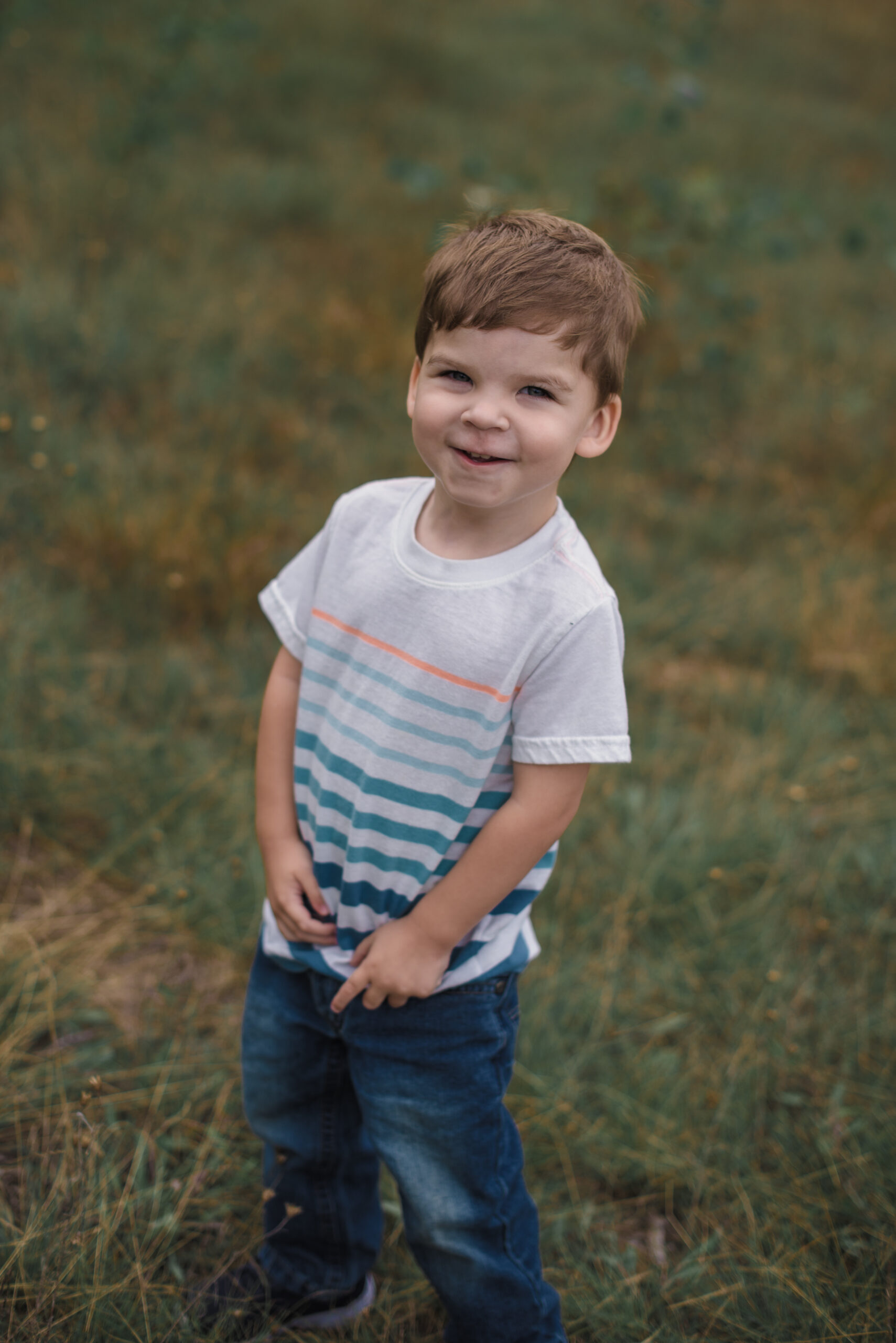 little boy laughing in family pictures in traverse city michigan