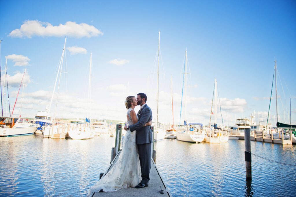 wedding photography of bride and groom on dock of grant traverse bay raverse city michigan