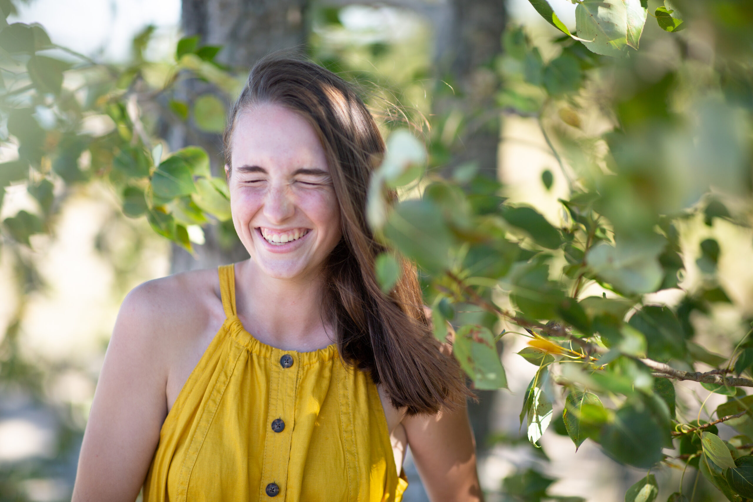 senior picture of girl in yellow dress at sleeping bear sand dunes in glen lake michigan