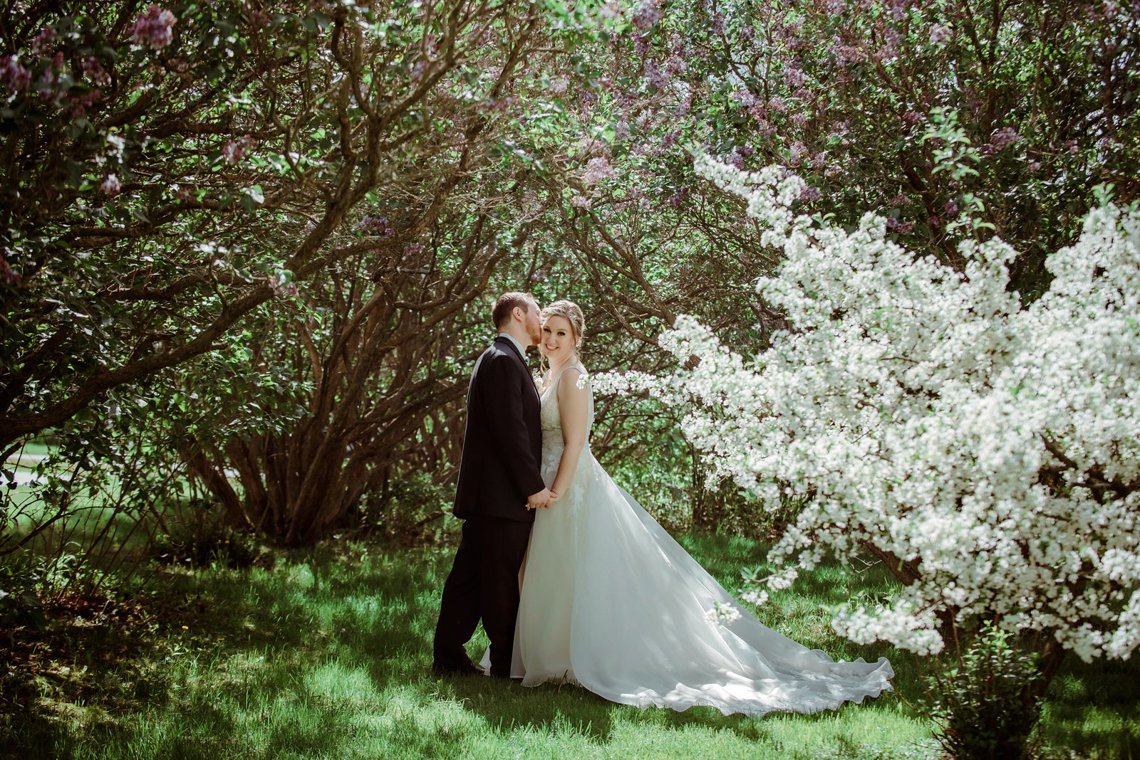 bride and groom kissing in spring wedding in traverse city michigan