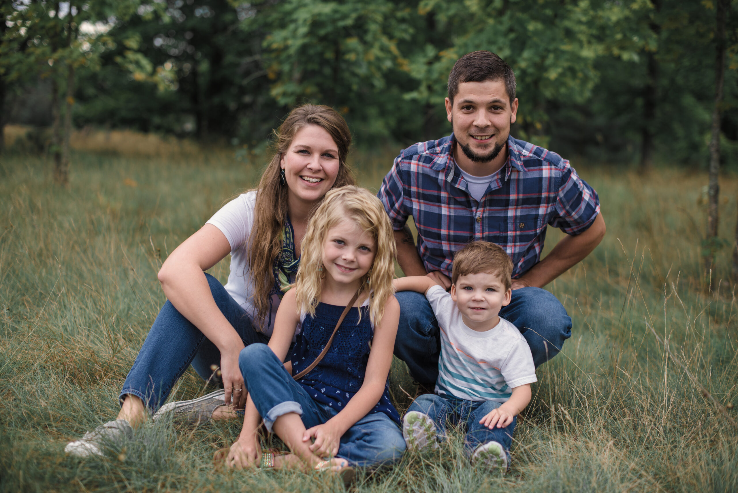 family of four in a happy posed picture in traverse city michigan