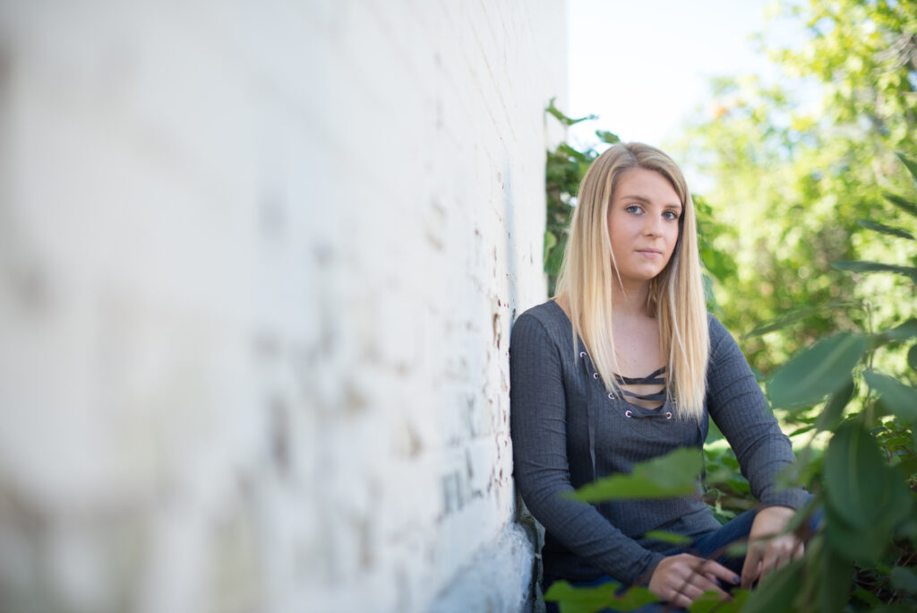 senior girl posing for senior picture at the grand traverse commons in traverse city michigan