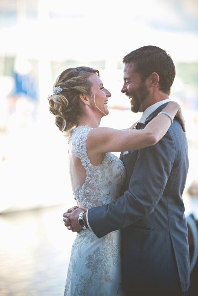 bride and groom candid dancing by lake michigan in traverse city