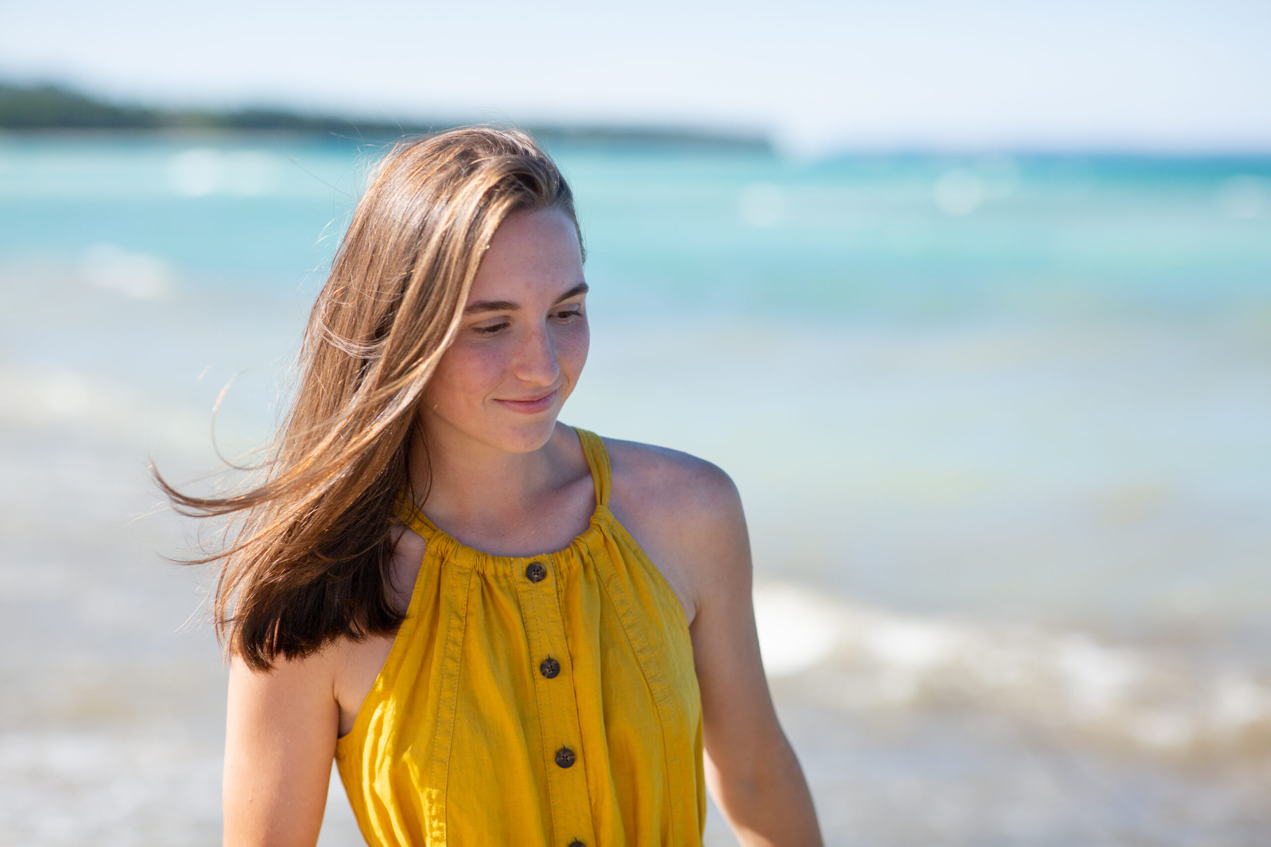 girl walking on beach during traverse city senior photos