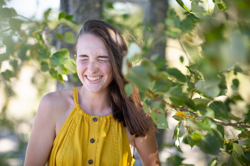 girl walking on beach during traverse city senior photos