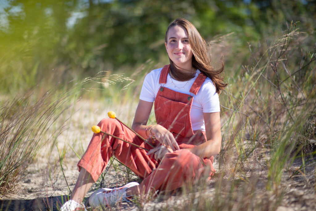 senior-girl-empire-beach-senior-photos-northern-michigan-photographer girl walking on beach during traverse city senior photos