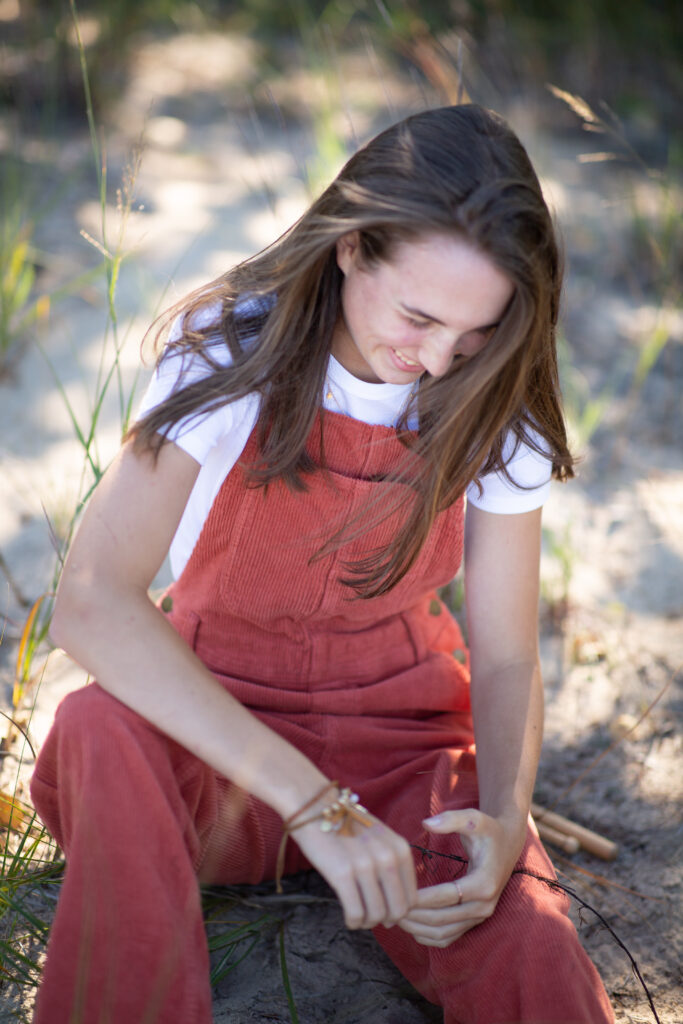 senior-girl-empire-beach-senior-photos-northern-michigan-photographer girl walking on beach during traverse city senior photos