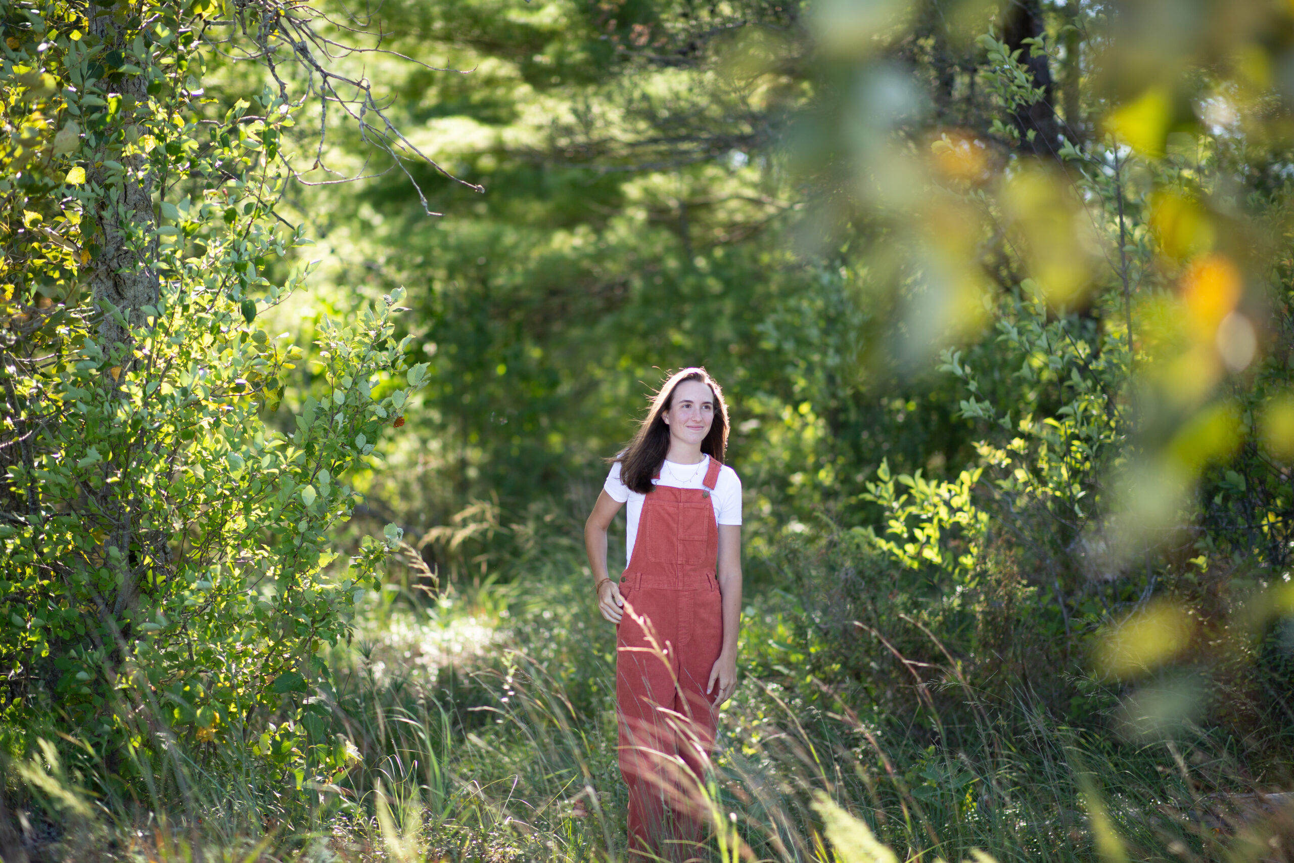 senior-girl-empire-beach-senior-photos-northern-michigan-photographer girl walking in woods during traverse city senior photos