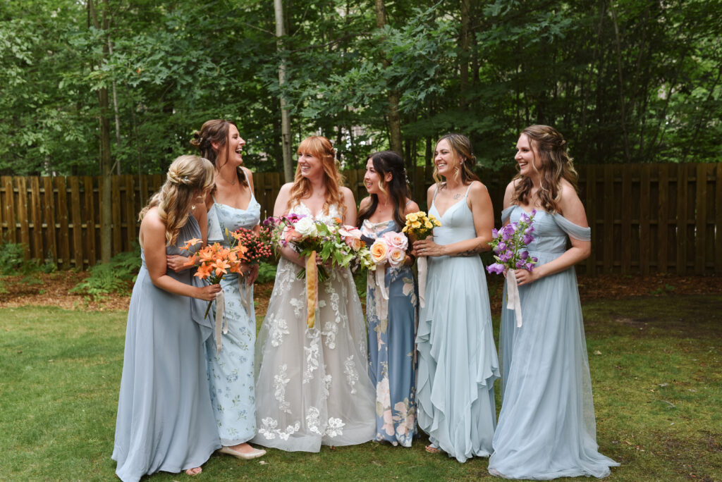 bride and bridesmaids at blue bridge event center in grawn michigan traverse city wedding photographer