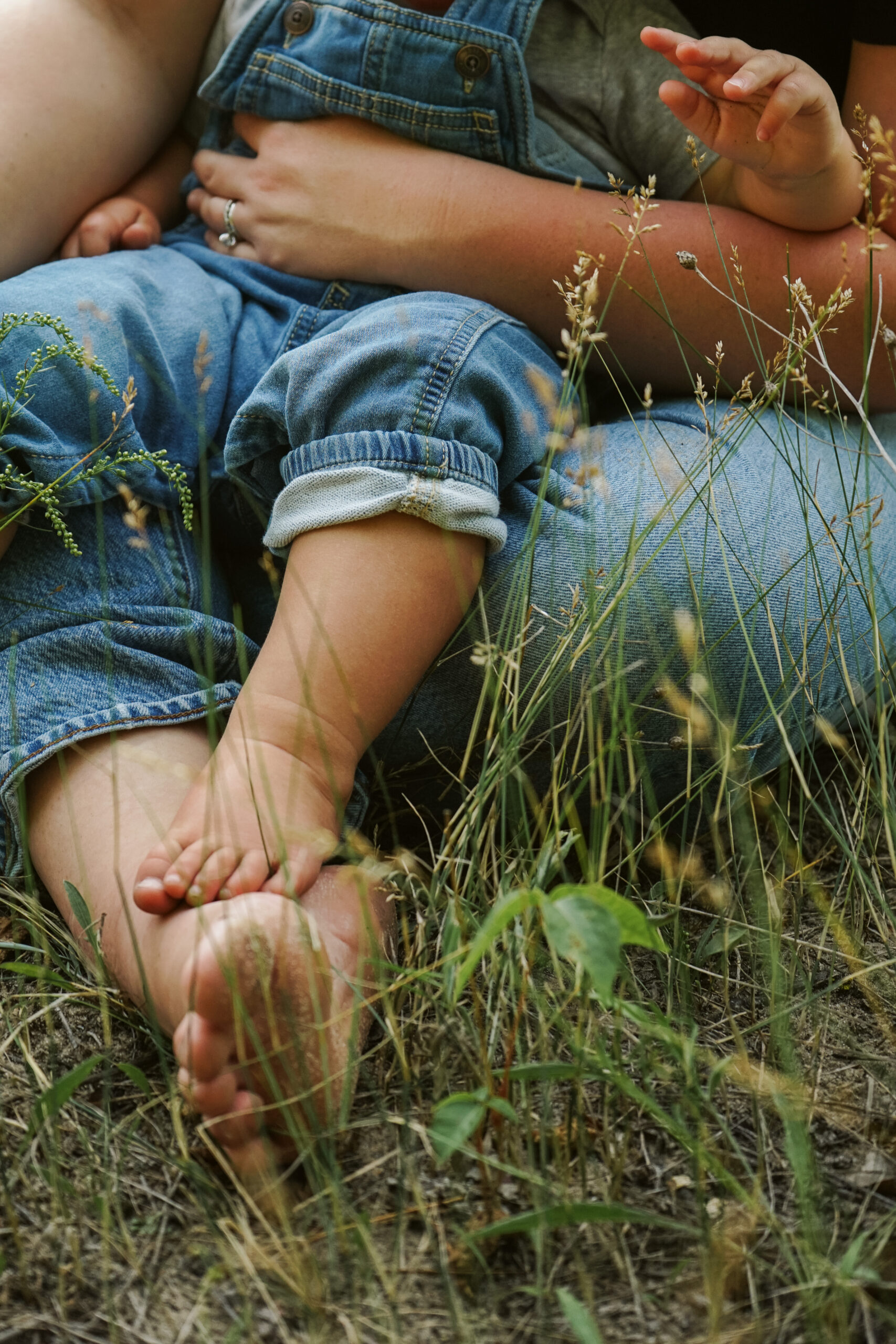 little boy sitting on his moms lap during family photos in empire michigan traverse city potographer