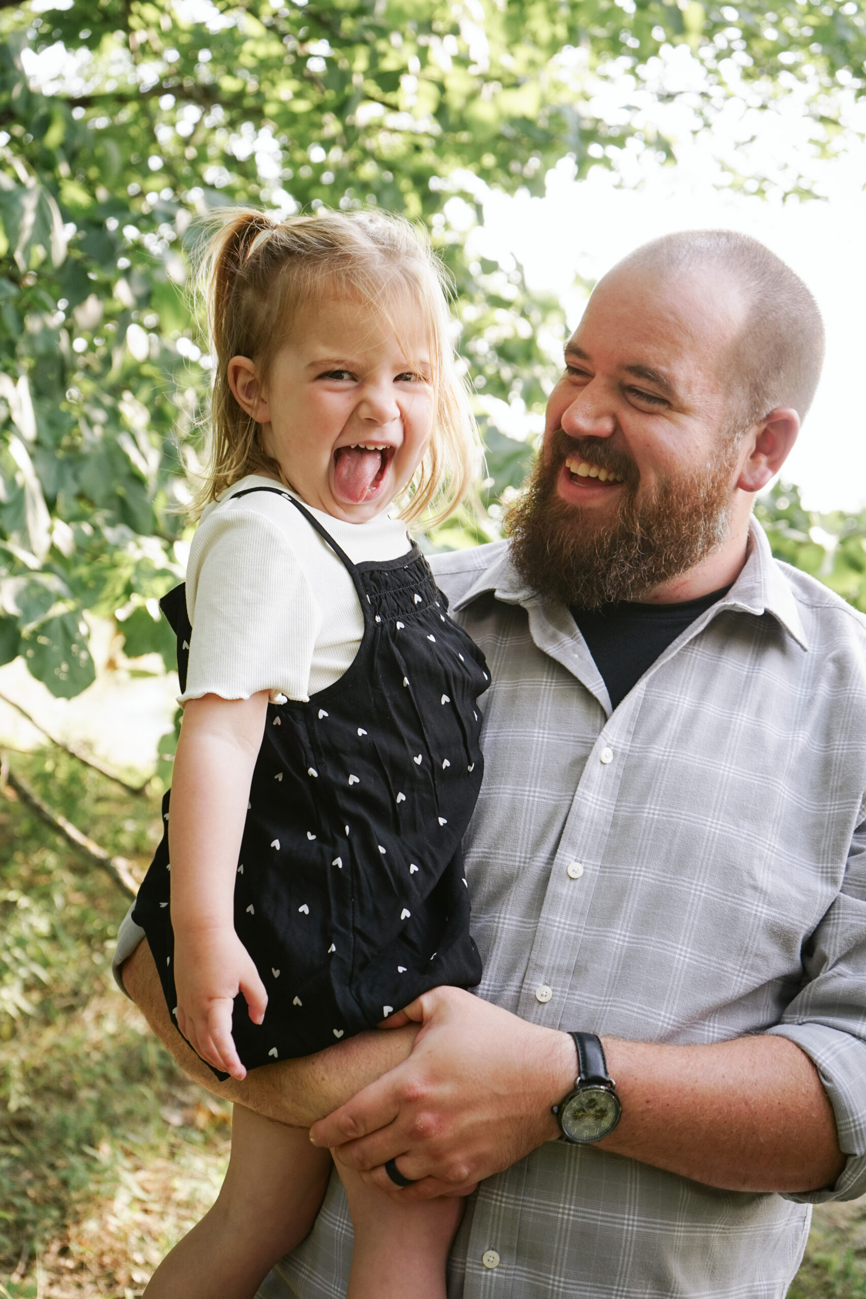 dad and daughter in woods during family photos in empire michigan traverse city potographer