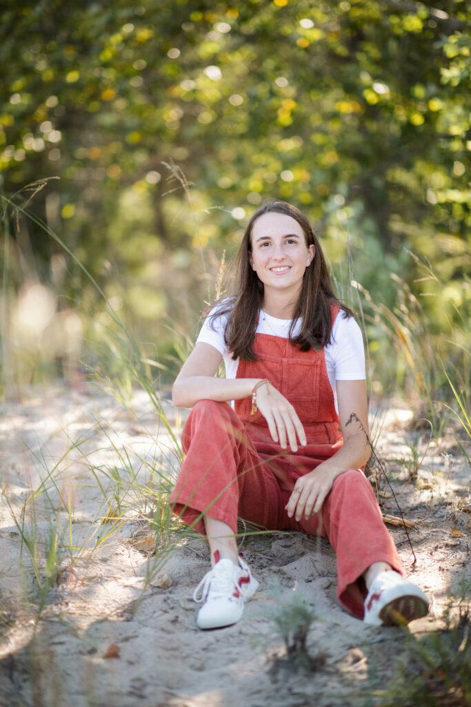 girl on empire beach taking senior pictures in empire michigan traverse city photographer