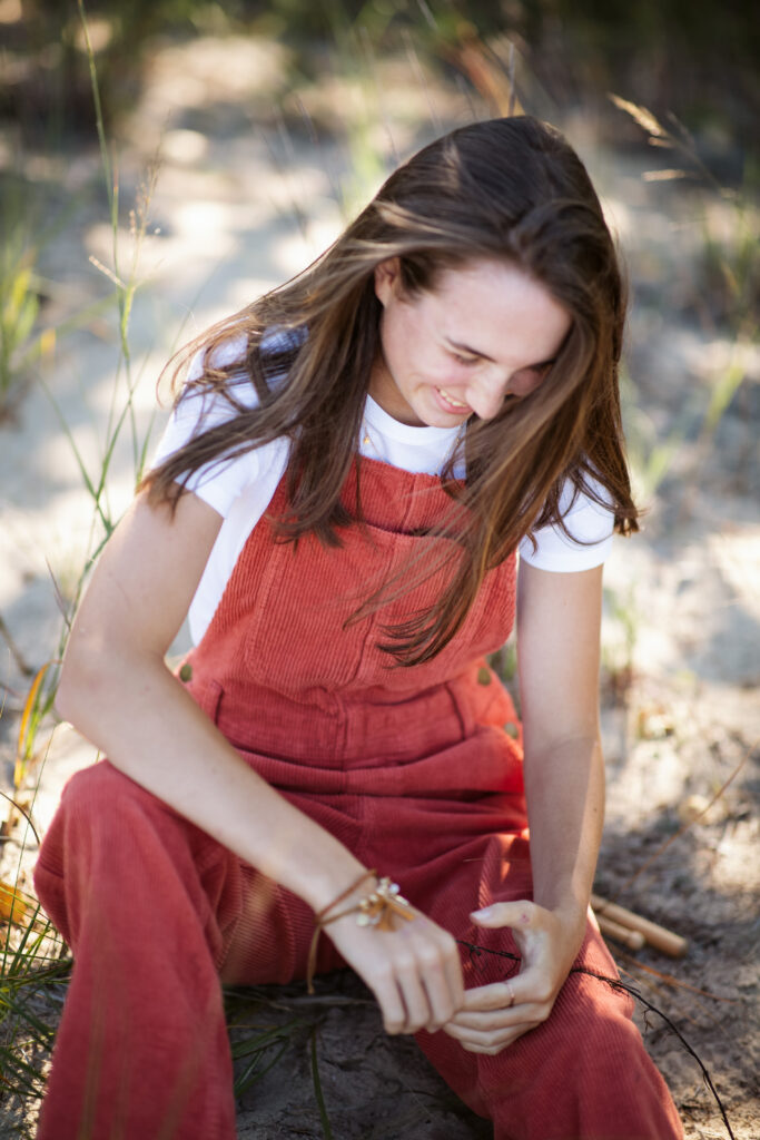 girl on empire beach taking senior pictures in empire michigan traverse city photographer