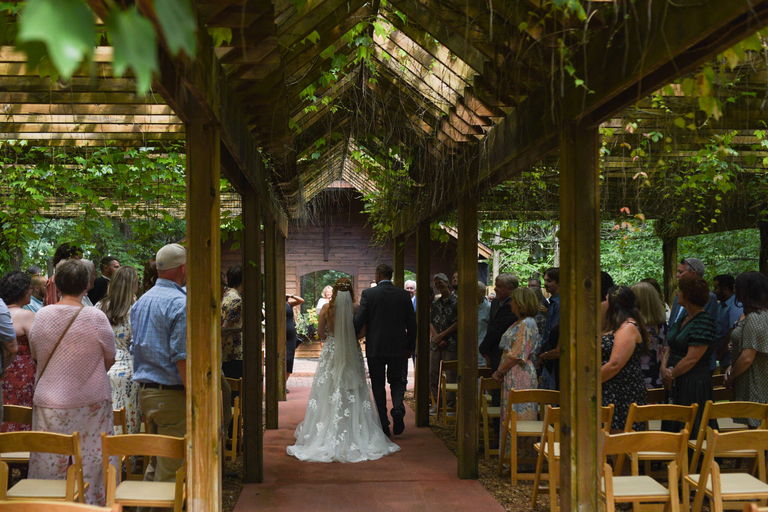 bride and father walking down aisle at wedding in traverse city michigan wedding photography