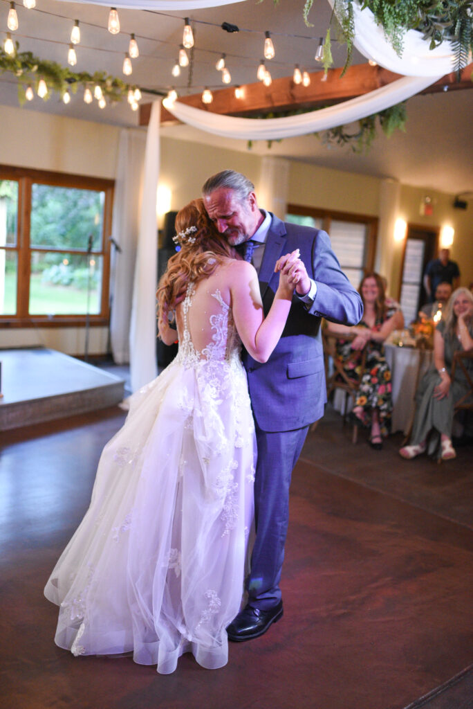 bride and father dancing during father daughter dance at wedding in traverse city michigan wedding photography