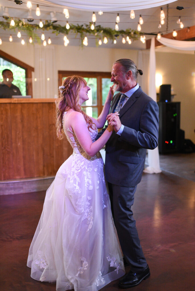 bride and father dancing during father daughter dance at wedding in traverse city michigan wedding photography