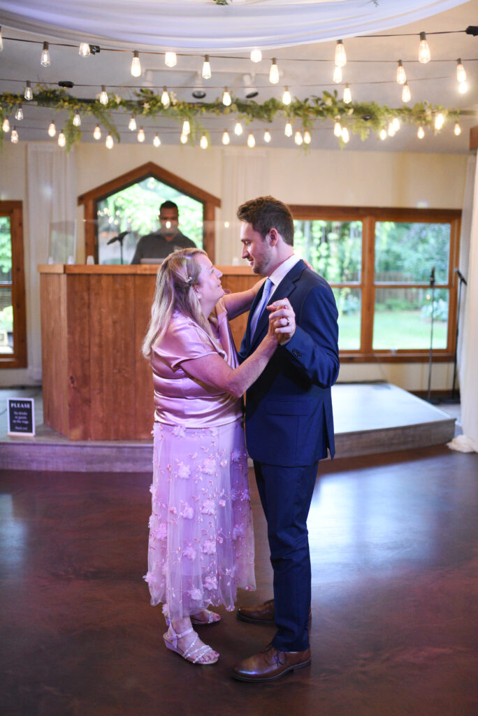 groom and mother dancing during mother son dance at wedding in traverse city michigan wedding photography
