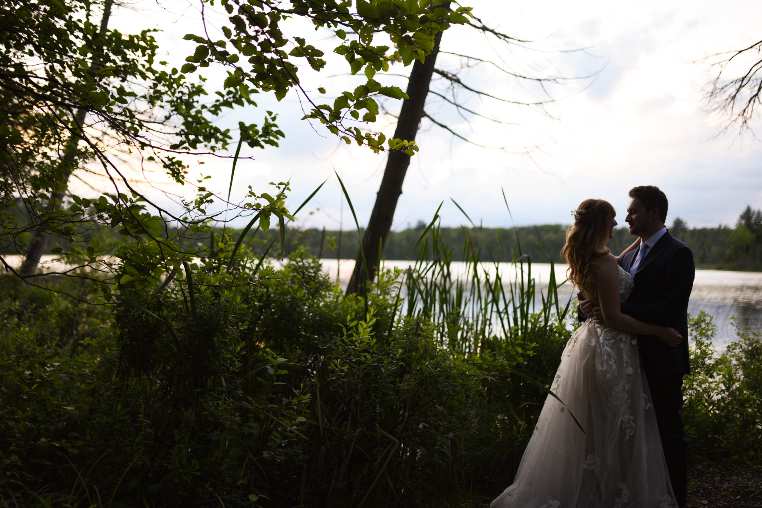 bride and groom during sunset at blue bridge event center at wedding in traverse city michigan wedding photography