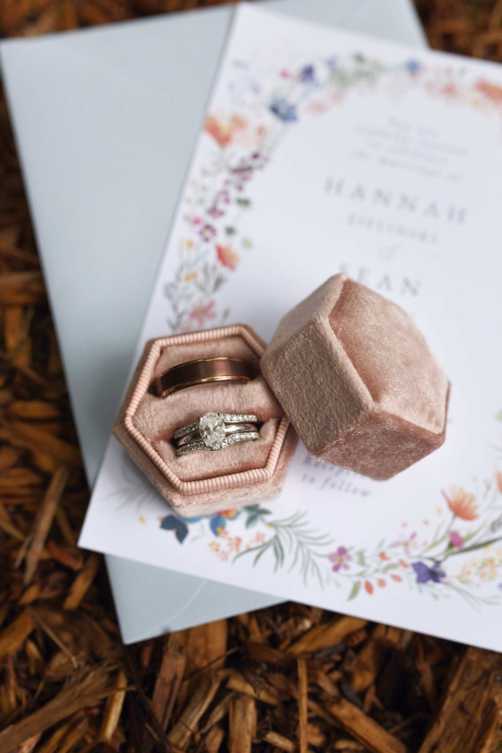 wedding rings on invitation at blue bridge event center wedding in traverse city michigan wedding photography