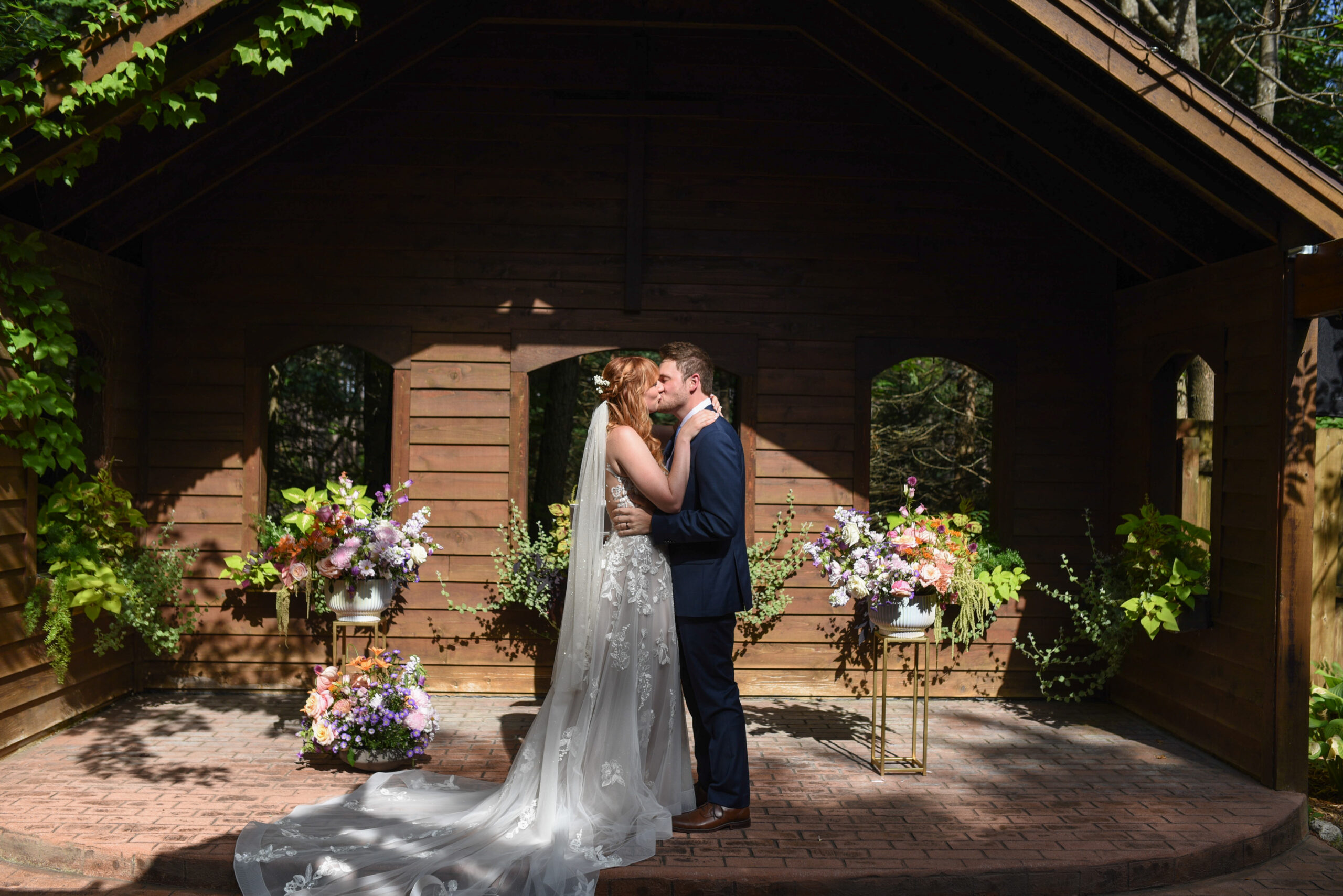 bride and groom kiss at blue bridge event center wedding in traverse city michigan wedding photography