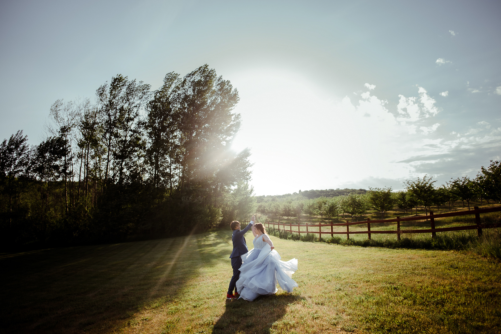 bride and groom dancing in field at starry night barn suttons bay michigan wedding photographer