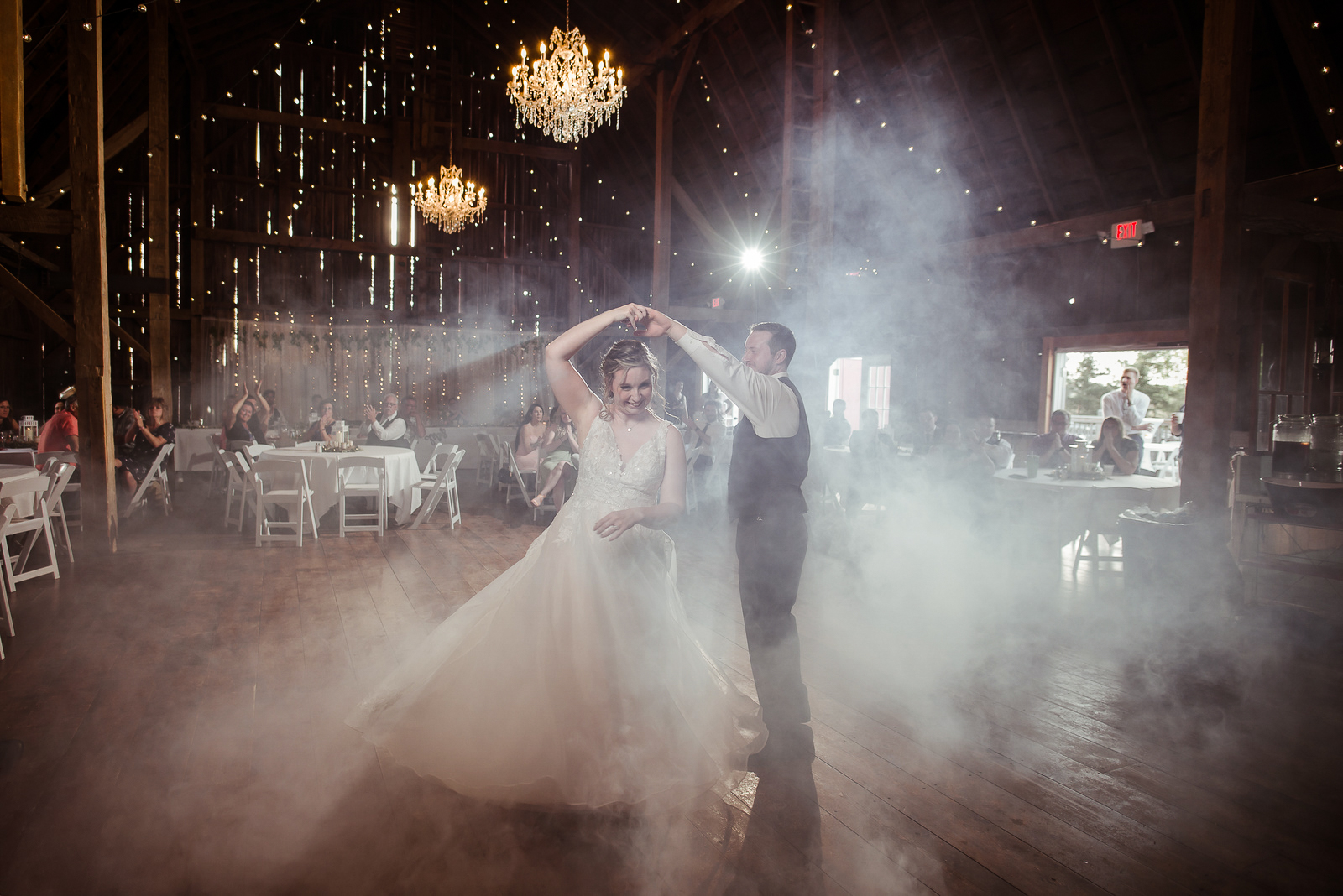bride and groom dancing during blue sky barn in elmira michigan wedding photographer