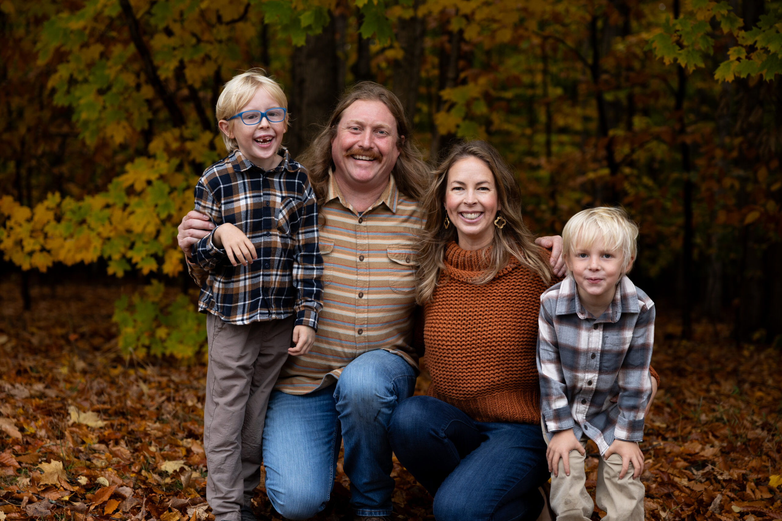 family photo in fall leaves in glen arbor michigan traverse city family photographer