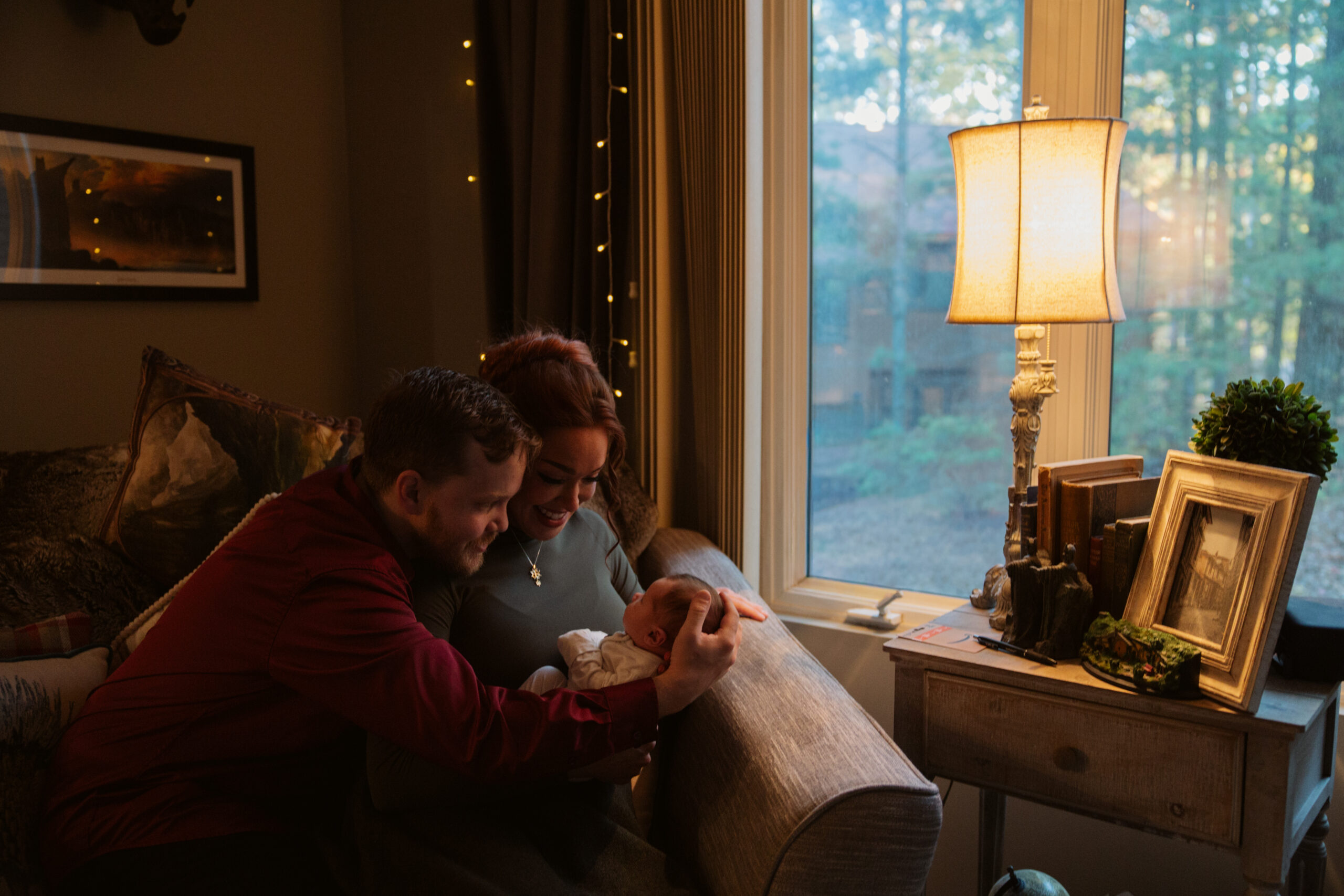 mom and dad with baby at home during newborn photos in traverse city michigan photographer