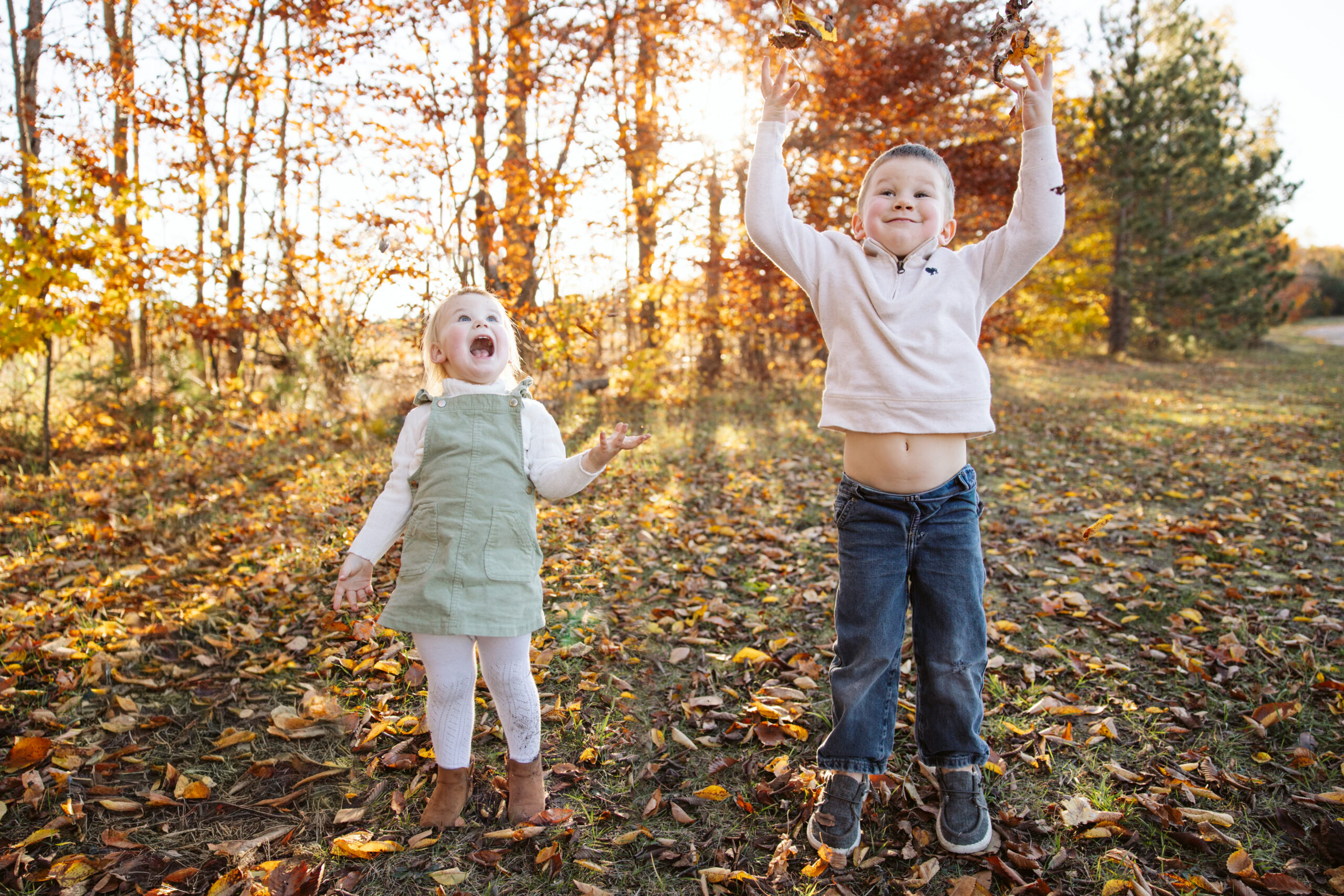 husband and wife kissing during family photos at grand traverse commons in traverse city michigan family photographer