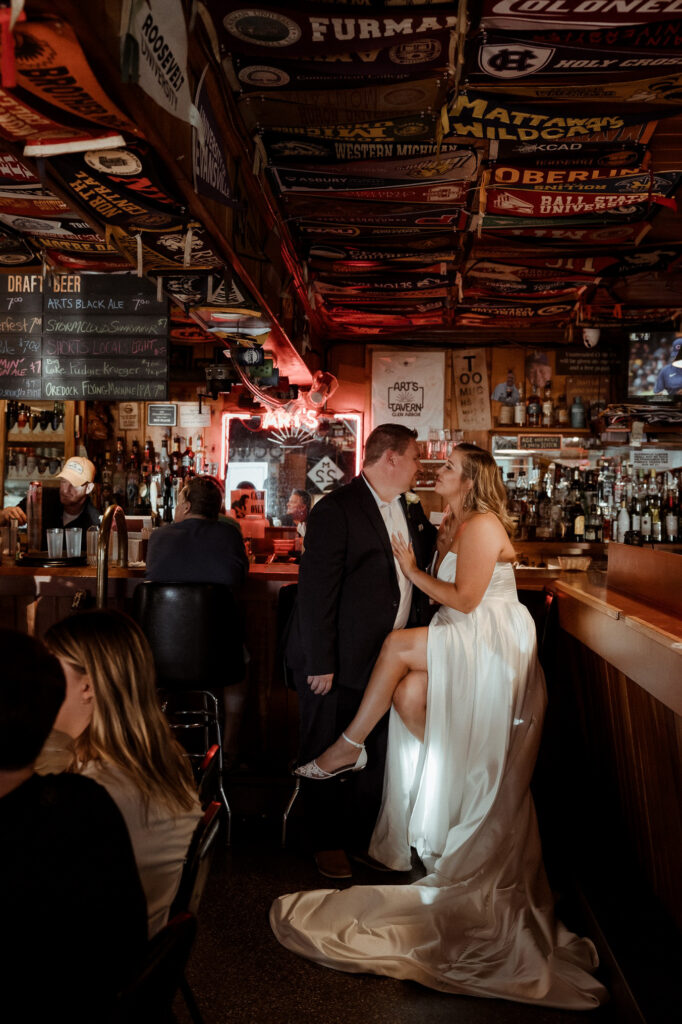 arts-tavern-glen-arbor-wedding-photographer bride and groom at wedding sitting at bar in glen arbor michigan wedding photography