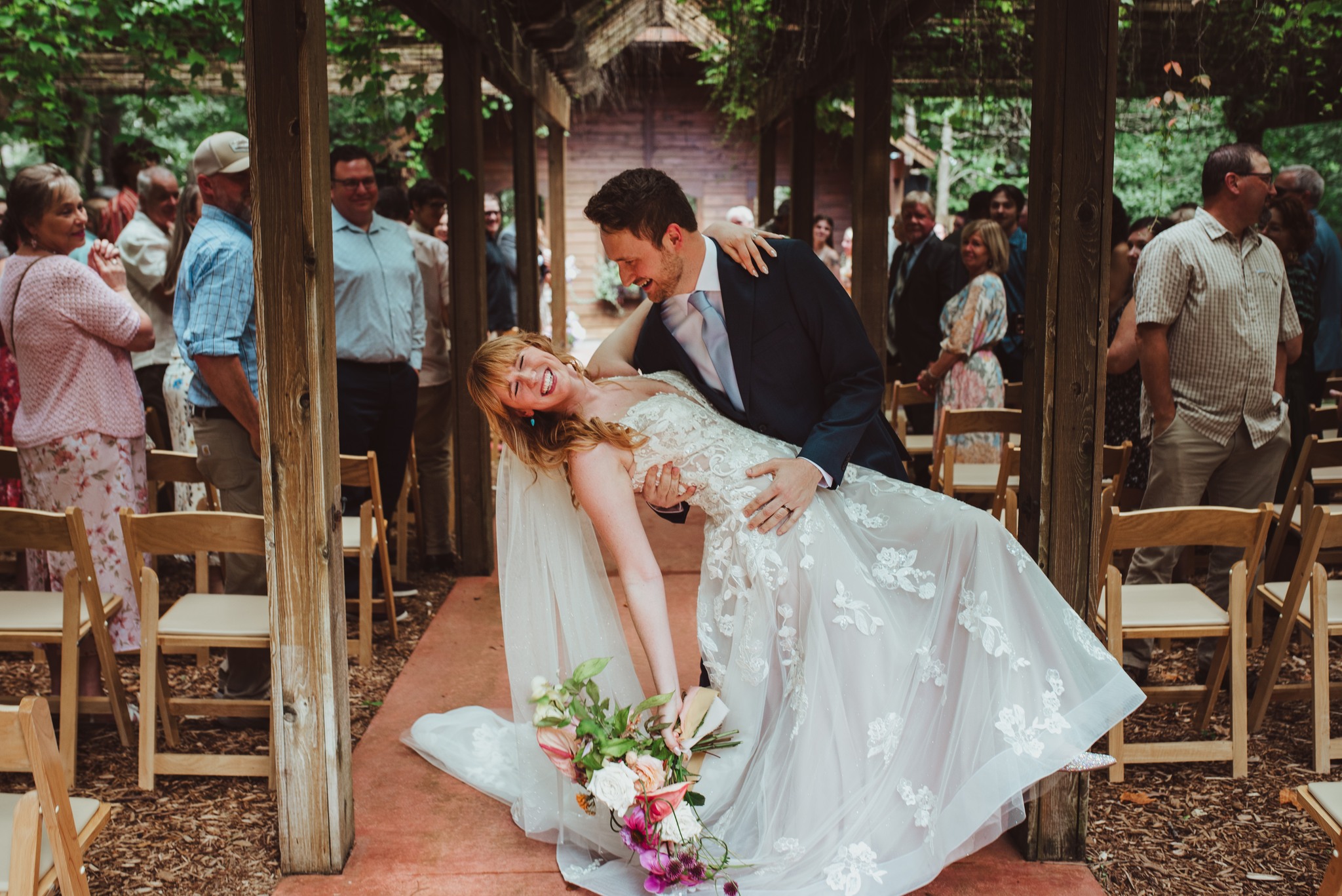 bride and groom laughing after ceremony in traverse city wedding photography