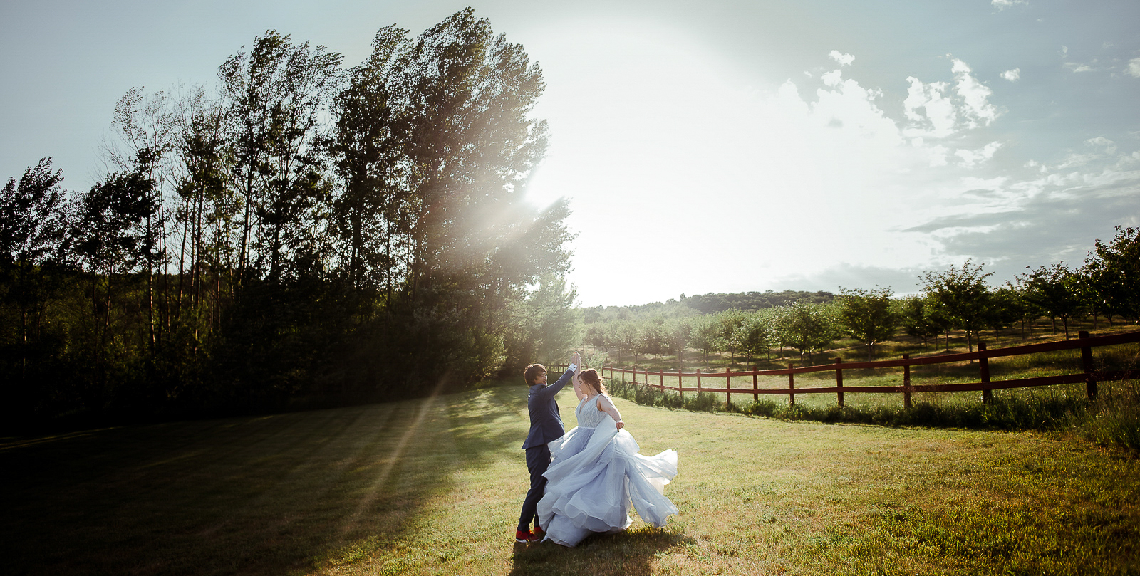 bride and groom dancing during blue sky barn in elmira michigan wedding photographer